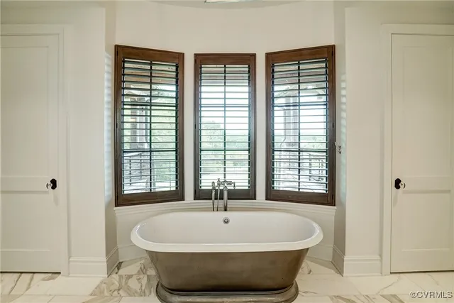 a large hall with stainless steel appliances wooden floor and a counter top space