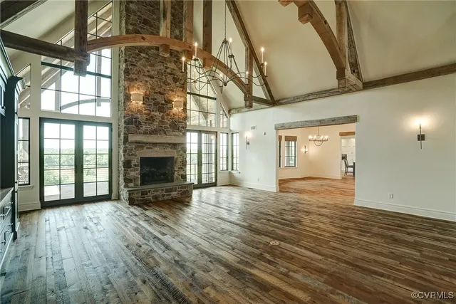 a kitchen with stainless steel appliances granite countertop a stove a sink dishwasher and a refrigerator with wooden floor