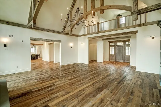 a kitchen that has a table chairs in it and wooden floors