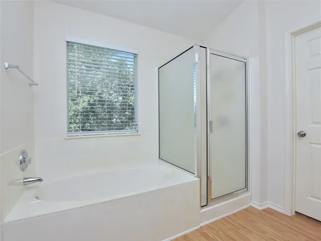 a bathroom with a bathtub and a shower