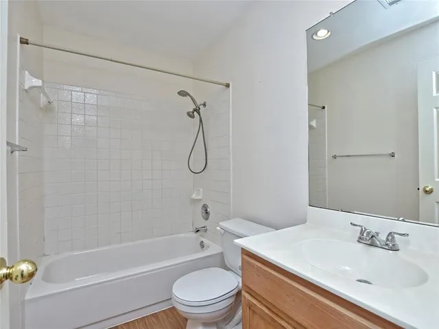 a bathroom with a sink a toilet and a bathtub