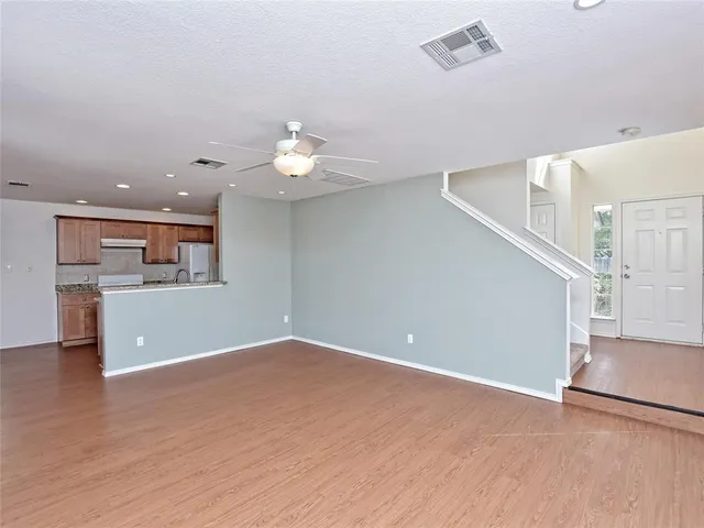 a view of a kitchen with furniture and a ceiling fan