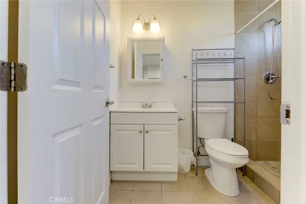 a bathroom with a granite countertop toilet sink and shower