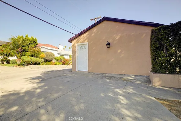 a view of a big house with wooden fence