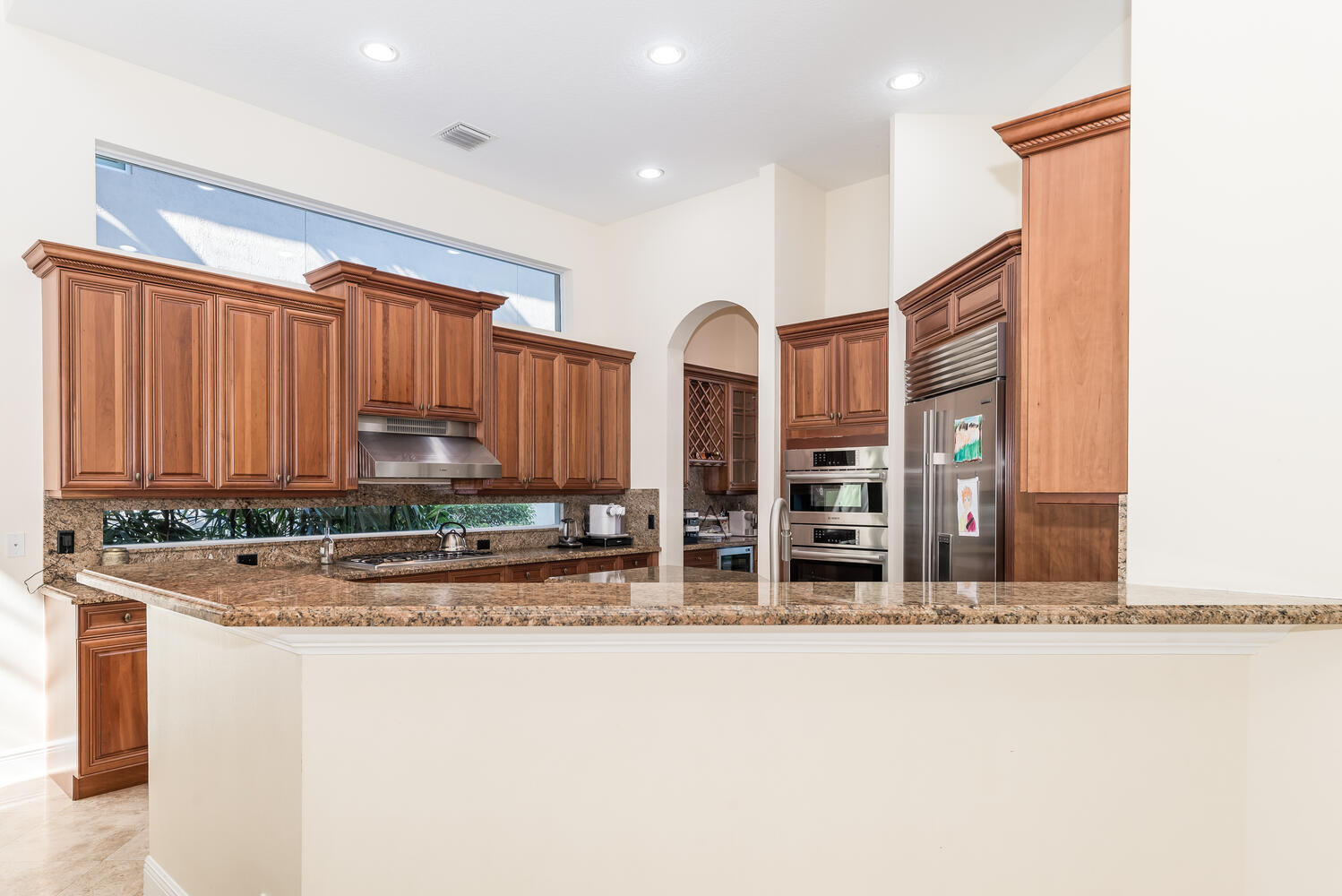 8849 Valhalla Drive Delray Beach, FL 33446 - Photo 12 of 32 a kitchen with stainless steel appliances a sink and a refrigerator