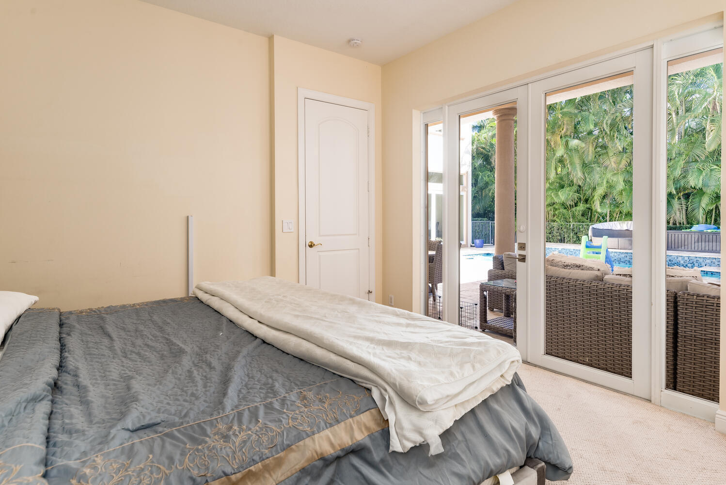 8849 Valhalla Drive Delray Beach, FL 33446 - Photo 28 of 32 a bedroom with a bed and large windows