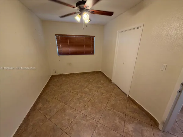 a view of an empty room with a fan