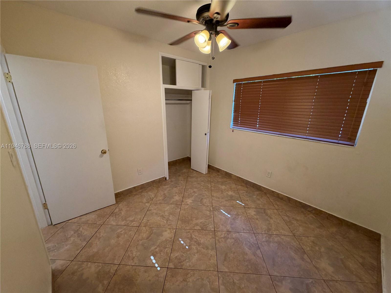 6090 West 5th Lane Hialeah, FL 33012 - Photo 13 of 28 a view of an empty room with a fan