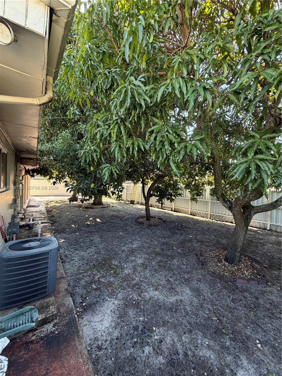 6090 West 5th Lane Hialeah, FL 33012 - Photo 21 of 28 a view of a yard with plants and trees