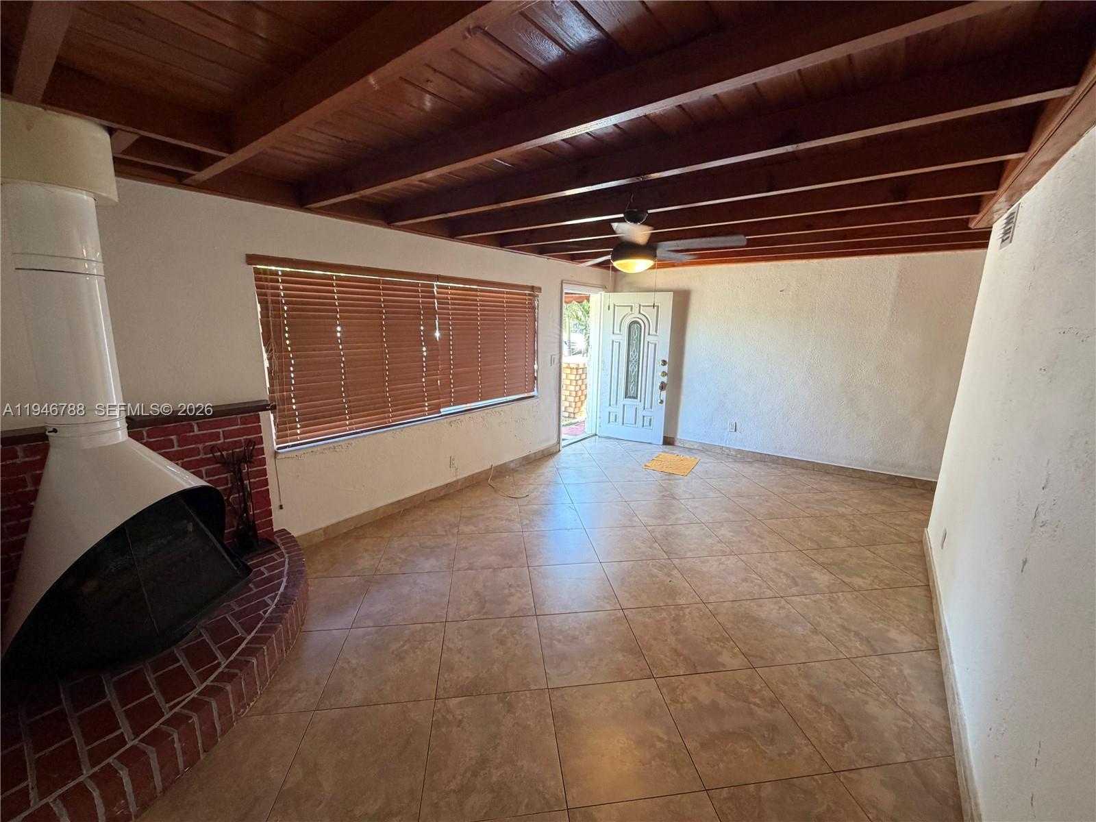 6090 West 5th Lane Hialeah, FL 33012 - Photo 4 of 28 a view of an empty room with wooden floor