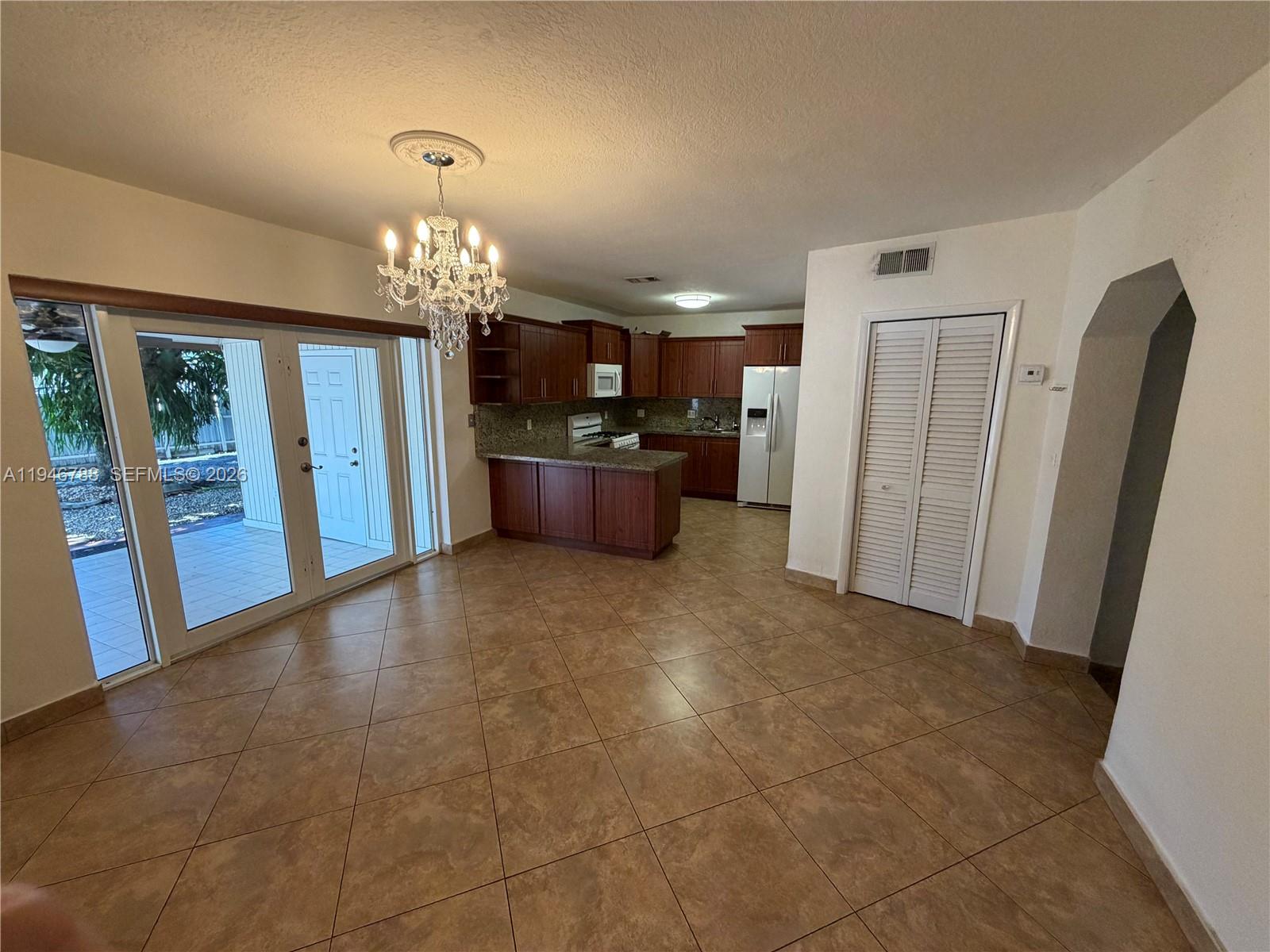 6090 West 5th Lane Hialeah, FL 33012 - Photo 8 of 28 a view of a kitchen with a sink and a refrigerator