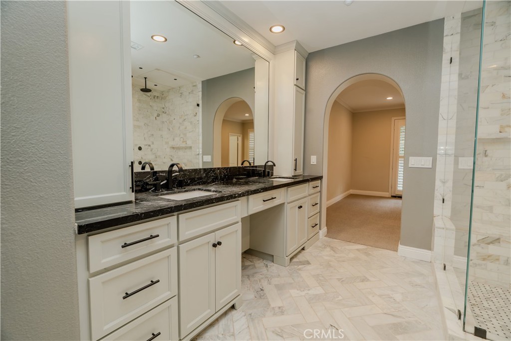 14 San Sovino Newport Coast, CA 92657 - Photo 15 of 44 a spacious bathroom with a granite countertop sink a mirror and a