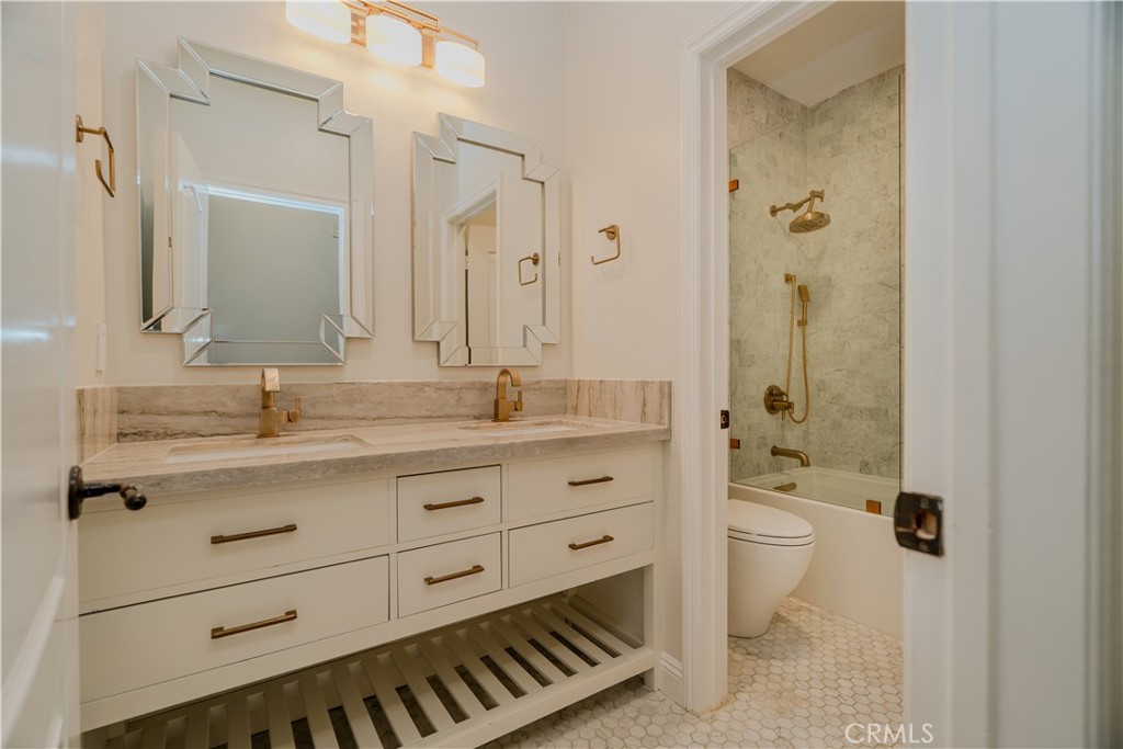14 San Sovino Newport Coast, CA 92657 - Photo 18 of 44 a bathroom with a granite countertop sink toilet a large mirror a shower and a bathtub