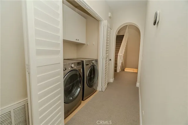 a view of a storage and utility room with washer and dryer