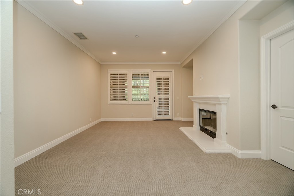 14 San Sovino Newport Coast, CA 92657 - Photo 23 of 44 an empty room with windows and fireplace