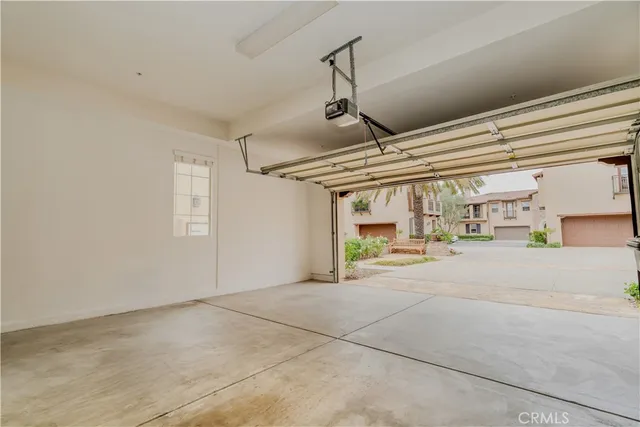 a big room with chandelier fan and windows