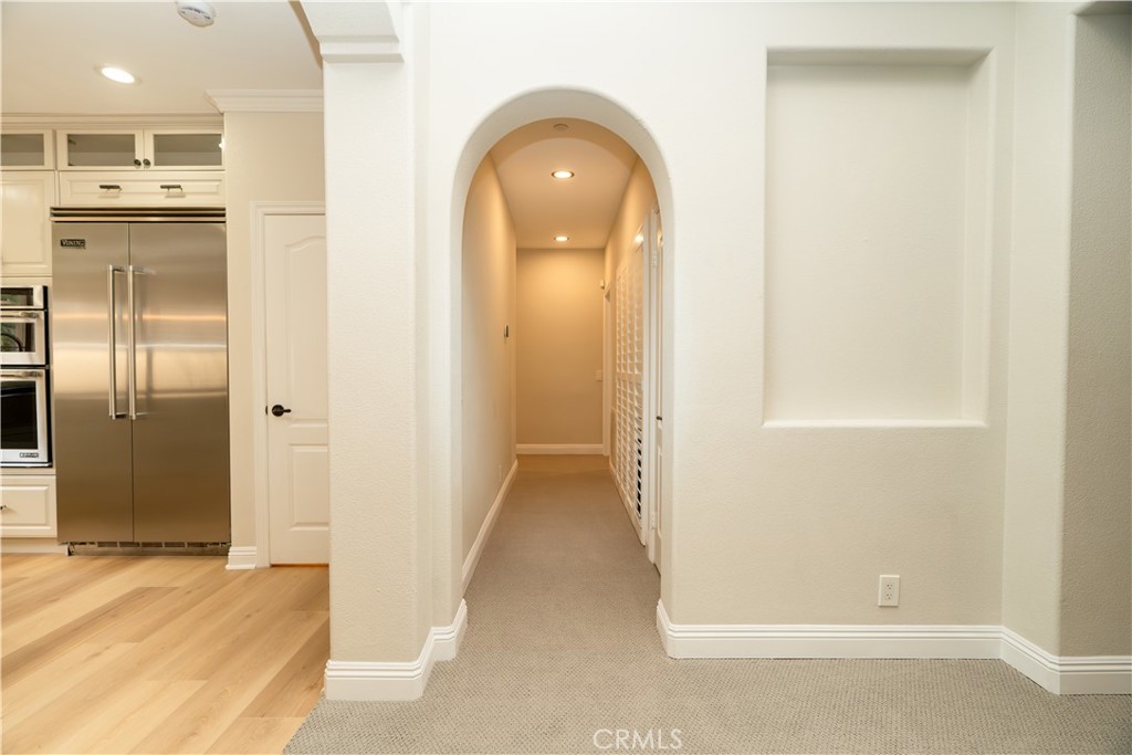14 San Sovino Newport Coast, CA 92657 - Photo 9 of 44 a view of a hallway with wooden floor