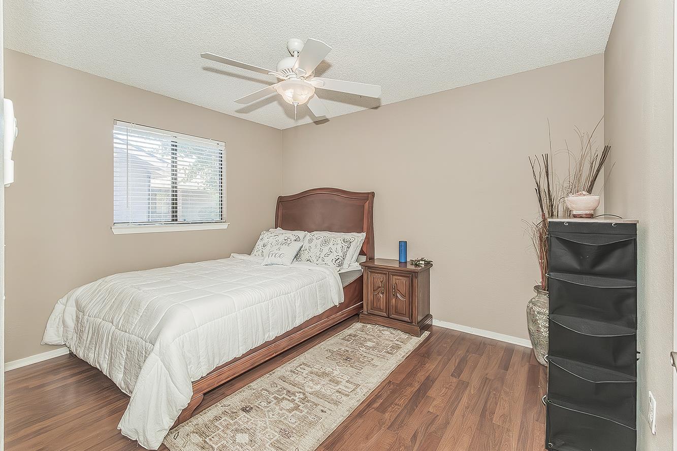1908 East Niles Avenue Fresno, CA 93720 - Photo 19 of 30 a bedroom with a bed and wooden floor