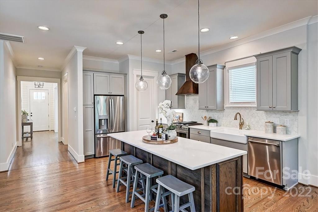911 Millbrook Road Charlotte, NC 28211 - Photo 11 of 43 a kitchen with a sink a center island cabinets and stainless steel appliances