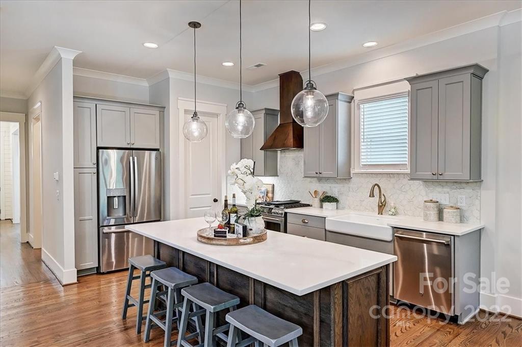 911 Millbrook Road Charlotte, NC 28211 - Photo 12 of 43 a kitchen with a table chairs sink and cabinets