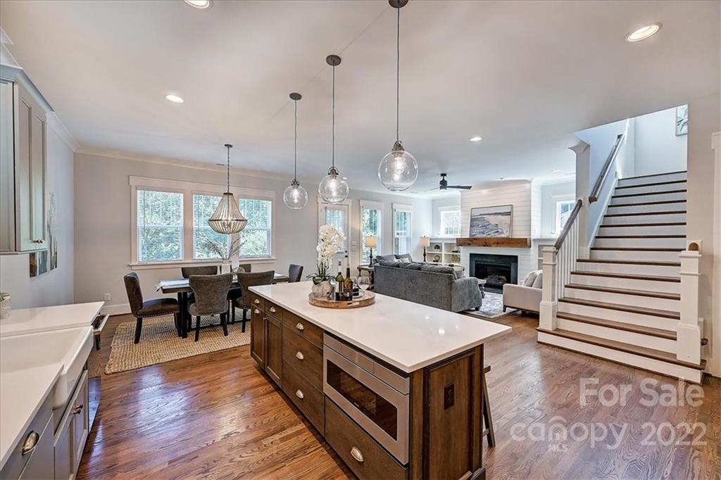 911 Millbrook Road Charlotte, NC 28211 - Photo 14 of 43 a view of a dining room and livingroom with furniture wooden floor a chandelier