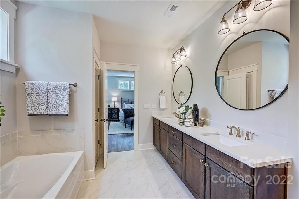 911 Millbrook Road Charlotte, NC 28211 - Photo 30 of 43 a bathroom with a sink and a mirror
