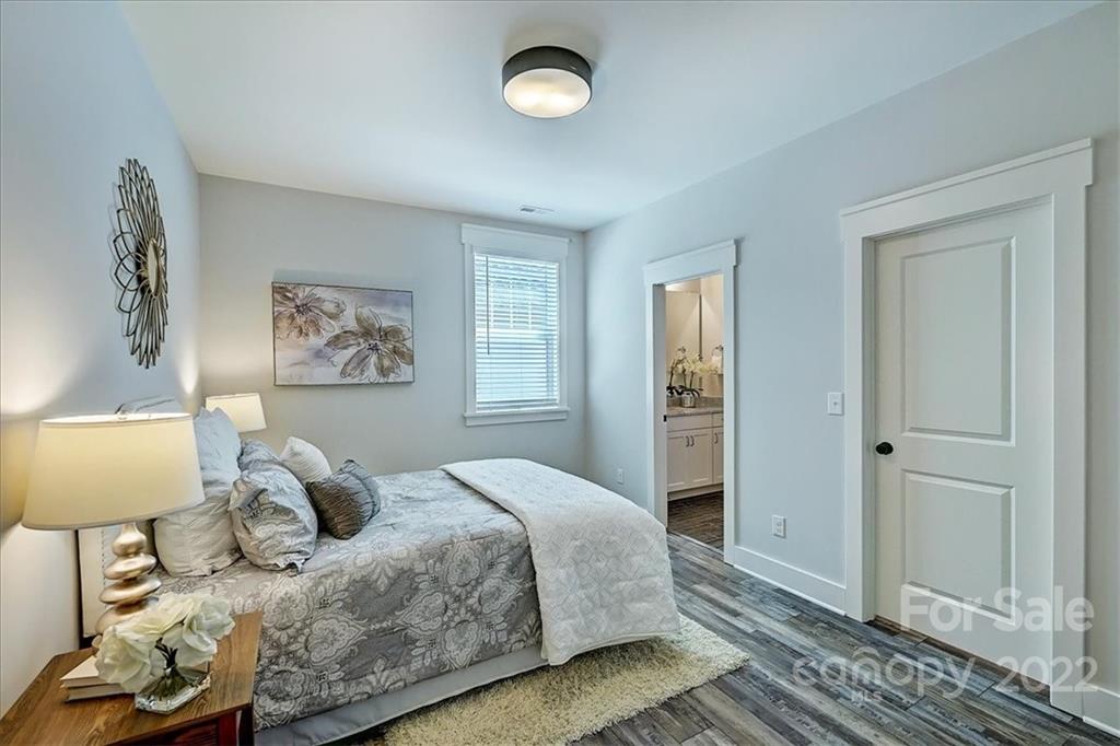 911 Millbrook Road Charlotte, NC 28211 - Photo 33 of 43 a bedroom with a bed and wooden floor