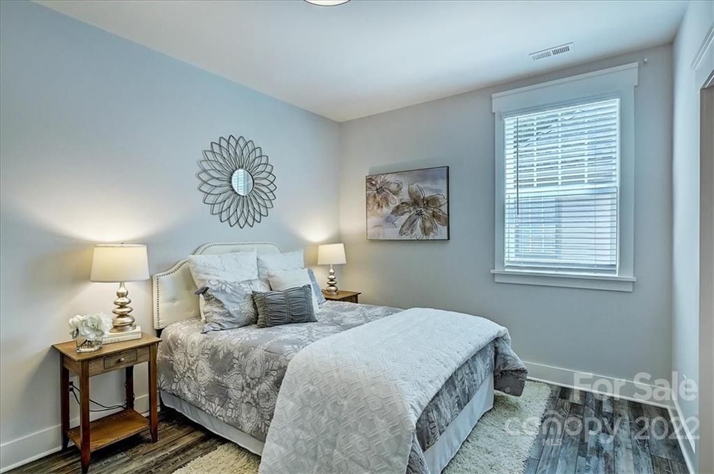 911 Millbrook Road Charlotte, NC 28211 - Photo 34 of 43 a bedroom with a bed and wooden floor