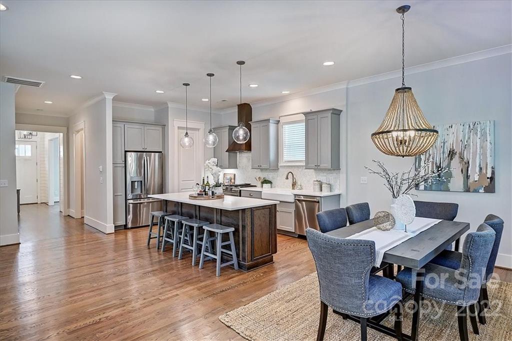 911 Millbrook Road Charlotte, NC 28211 - Photo 10 of 43 a dining room with furniture a chandelier and kitchen view