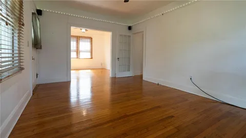 a view of a porch with wooden floor and fence