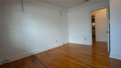 a front view of a house with a garden and yard