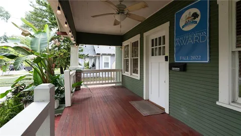 a view of a house with a yard and wooden fence