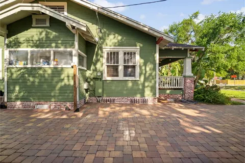 an aerial view of a house with garden space and street view