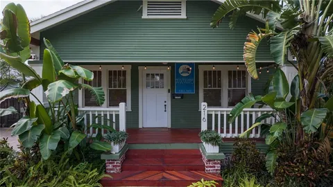 a view of a hallway with wooden floor and closet