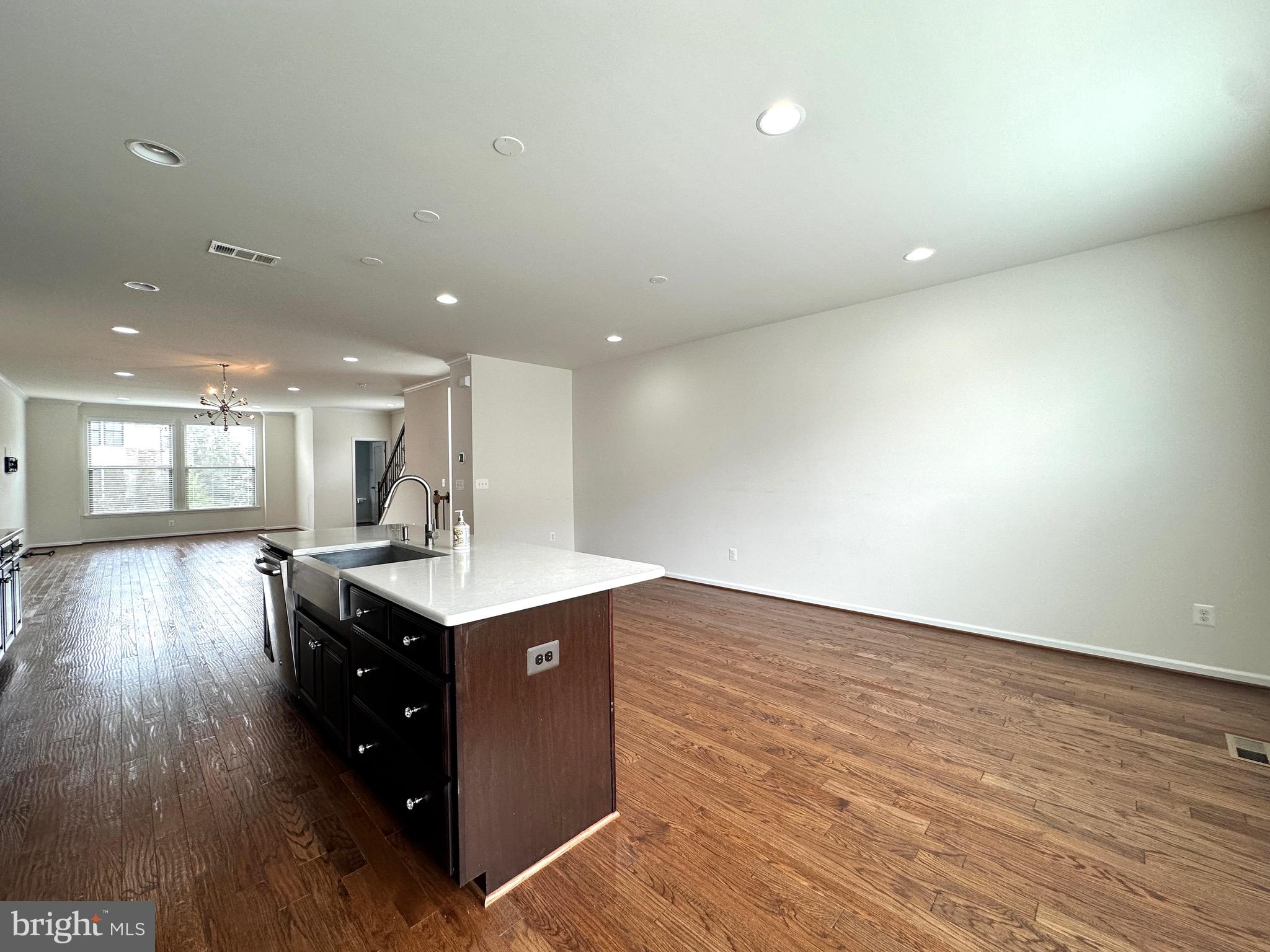 23451 Epperson Square Brambleton, VA 20148 - Photo 16 of 42 a kitchen with a sink and wooden floor