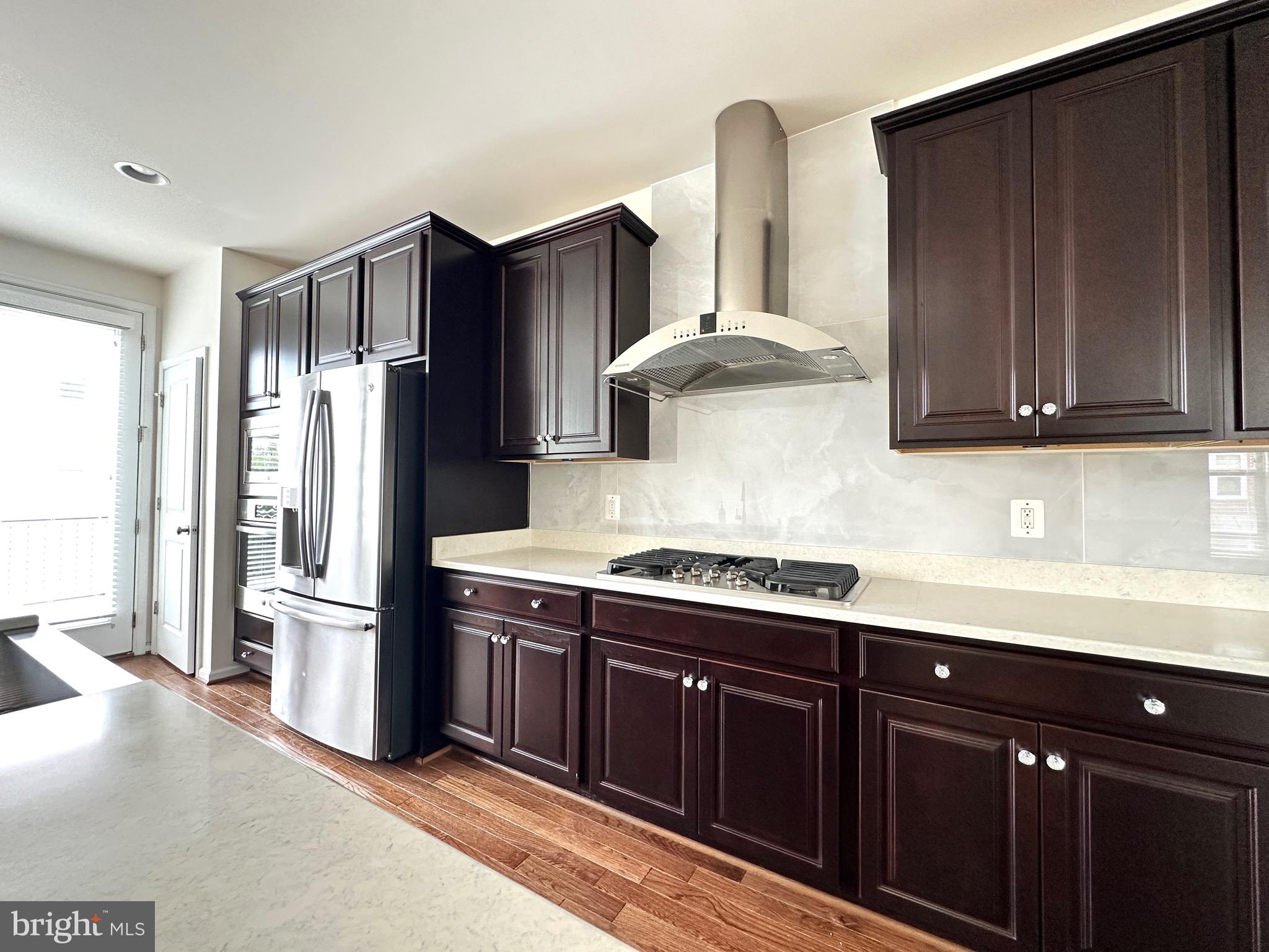 23451 Epperson Square Brambleton, VA 20148 - Photo 20 of 42 a kitchen with stainless steel appliances granite countertop a refrigerator and a sink