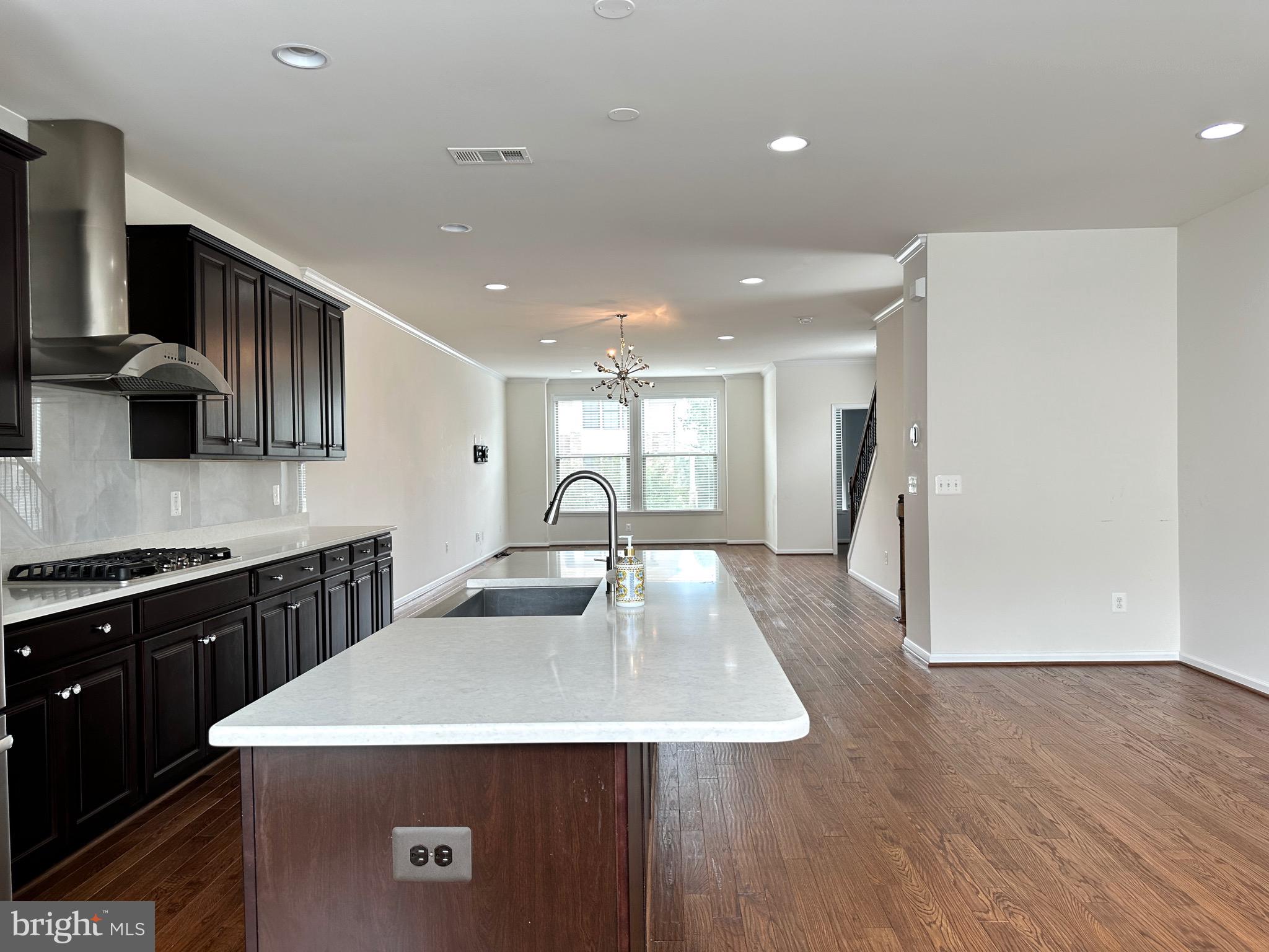23451 Epperson Square Brambleton, VA 20148 - Photo 21 of 42 a kitchen with stainless steel appliances granite countertop a sink dishwasher a stove and a refrigerator with wooden floor