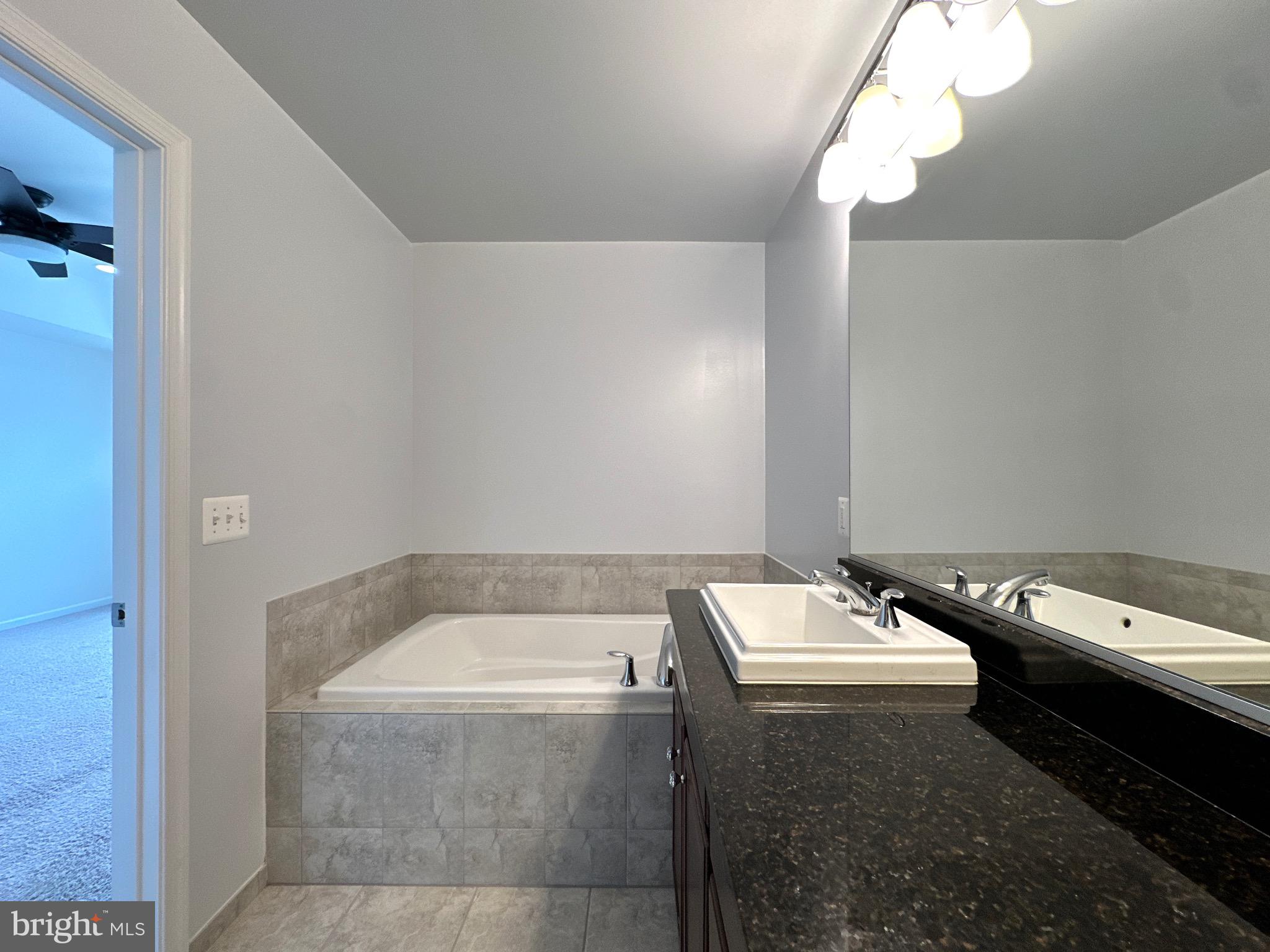 23451 Epperson Square Brambleton, VA 20148 - Photo 28 of 42 a bathroom with a granite countertop sink and a toilet