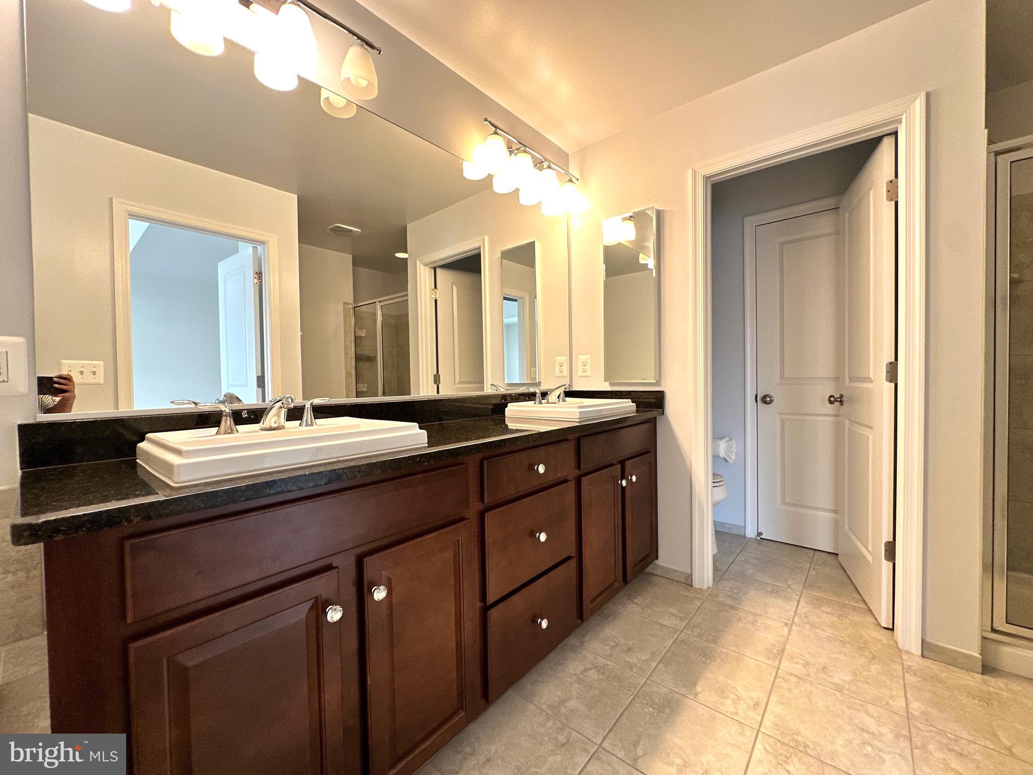 23451 Epperson Square Brambleton, VA 20148 - Photo 29 of 42 a bathroom with a double vanity sink and a mirror