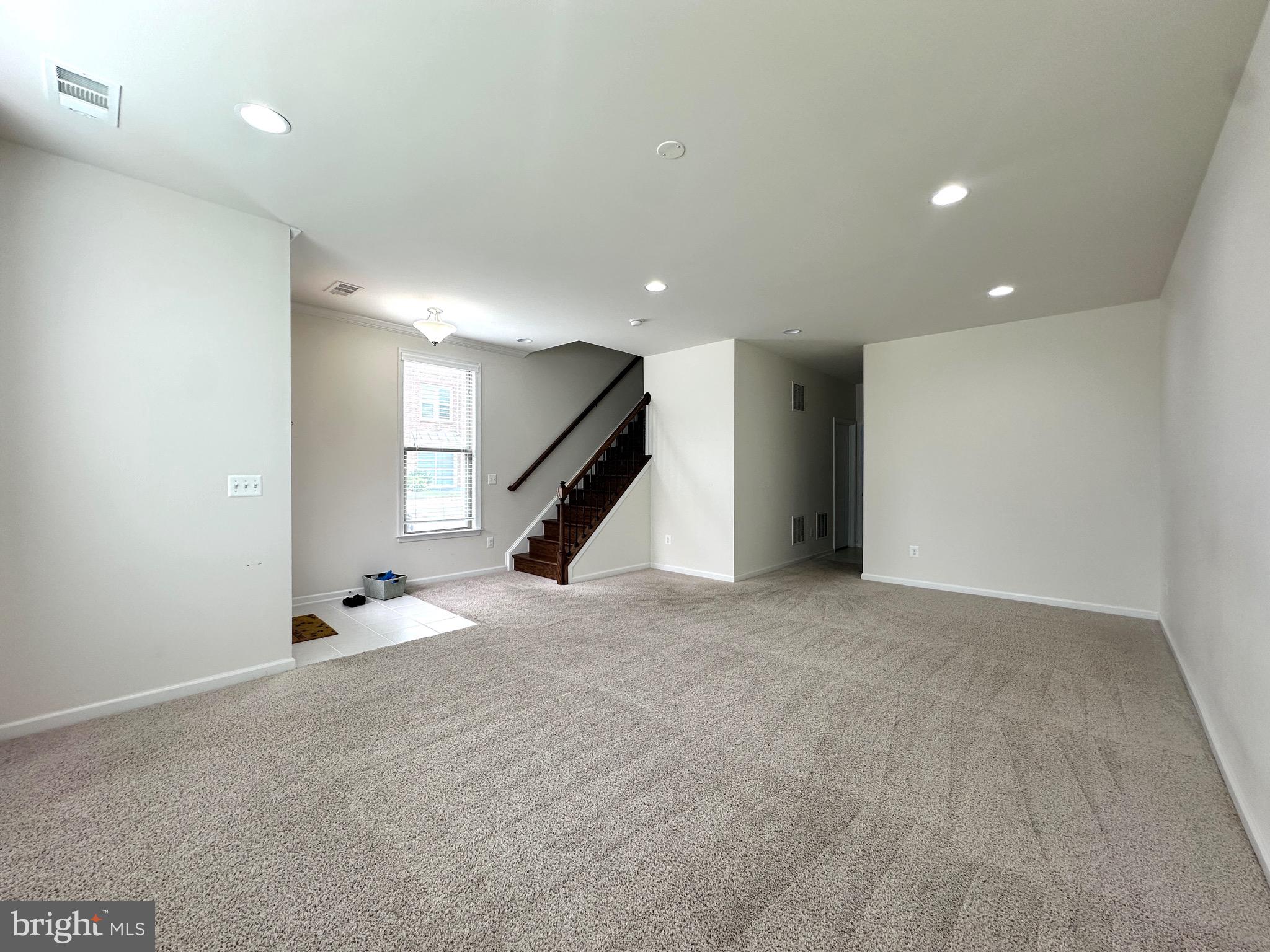 23451 Epperson Square Brambleton, VA 20148 - Photo 4 of 42 an empty room with staircase and stairs