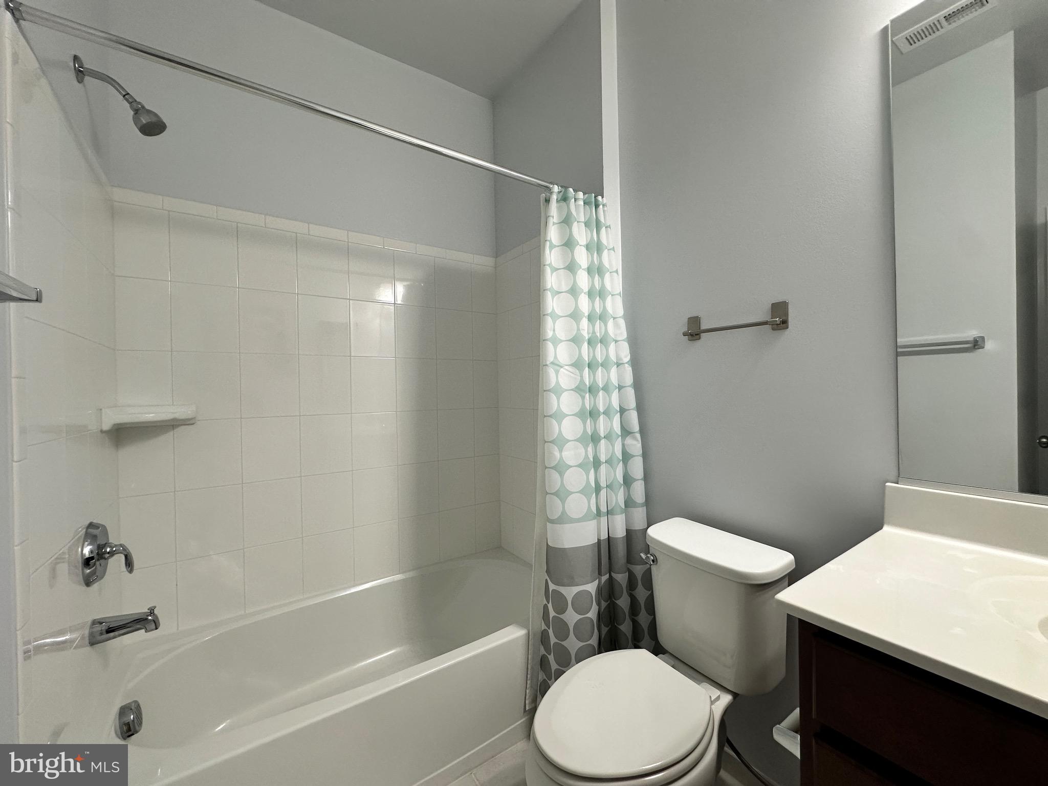 23451 Epperson Square Brambleton, VA 20148 - Photo 6 of 42 a white toilet and tub next to a bathroom sink