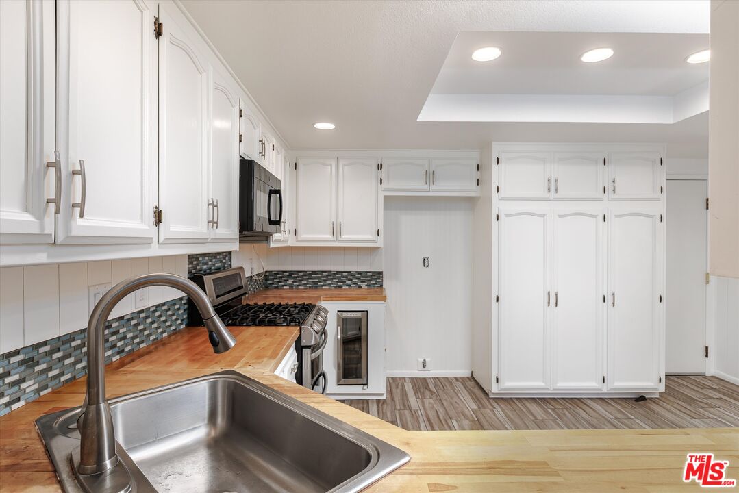 1108 Via Mavis Santa Maria, CA 93455 - Photo 12 of 28 a kitchen with granite countertop a stove a sink and a refrigerator
