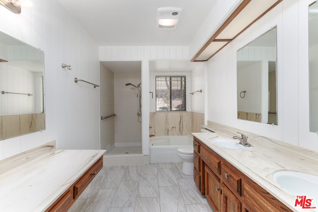 1108 Via Mavis Santa Maria, CA 93455 - Photo 16 of 28 a spacious bathroom with a granite countertop sink and a mirror