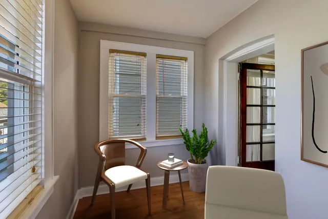 a view of a room with wooden floor and windows