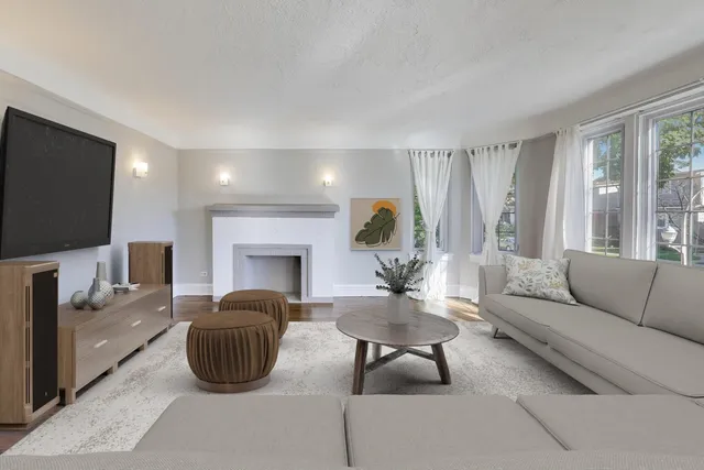a view of an empty room with a fireplace and a window