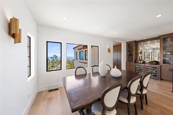 a dining room with furniture and wooden floor