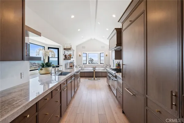 a view of a kitchen with a sink and wooden floor