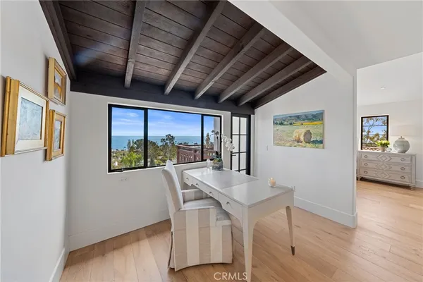 a dining room with furniture and a floor to ceiling window