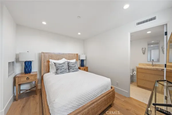 a bedroom with a bed and a view of living room