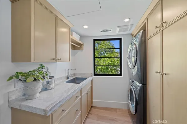 a kitchen with a sink window and refrigerator